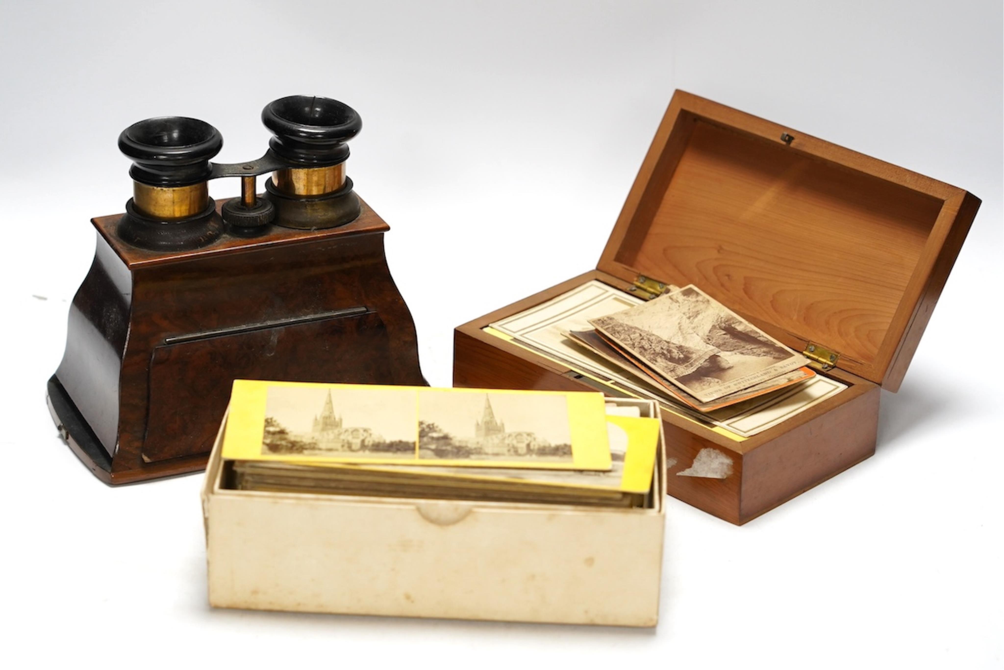 A late 19th century cased stereoscopic viewer together with topographical and other cards. Condition - fair